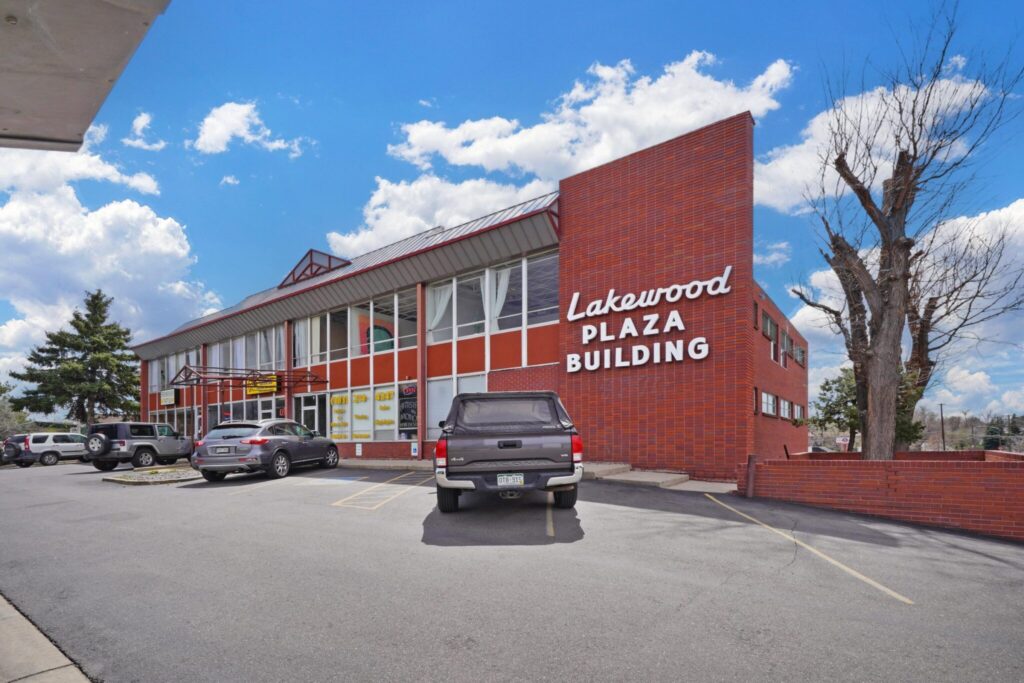 Exterior of the Lakewood Plaza Building at 8790 W Colfax Ave, a three-story brick office and retail building