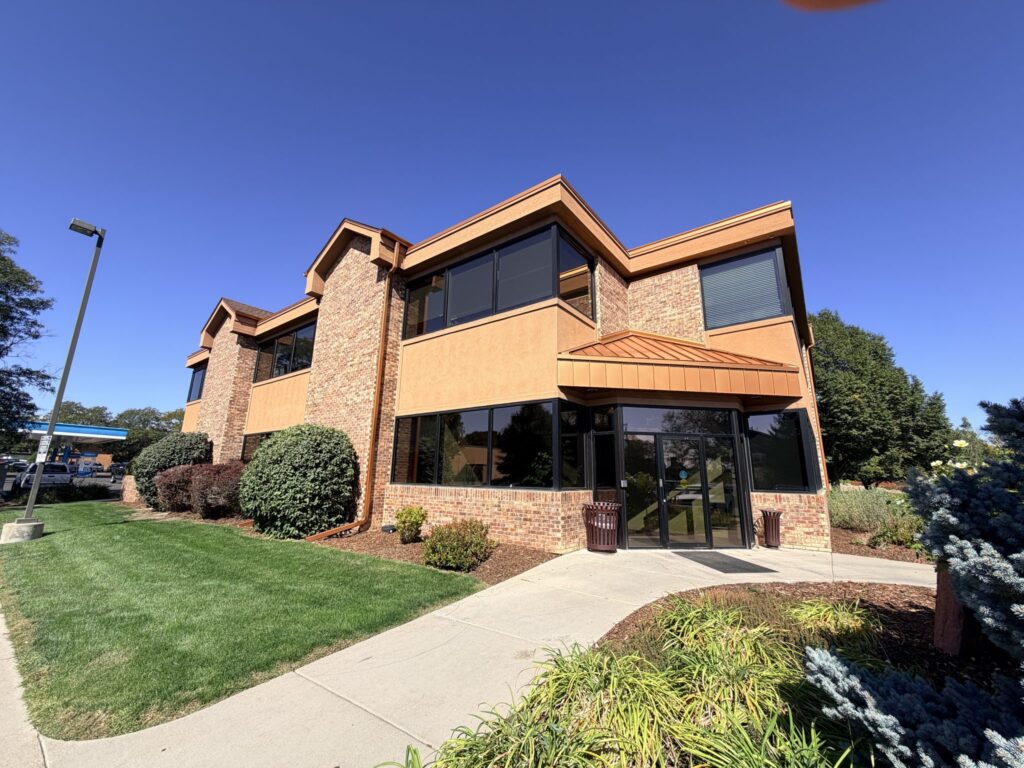 Main entry of 1140 W South Boulder Rd, a two-story brick medical office building in Lafayette, CO