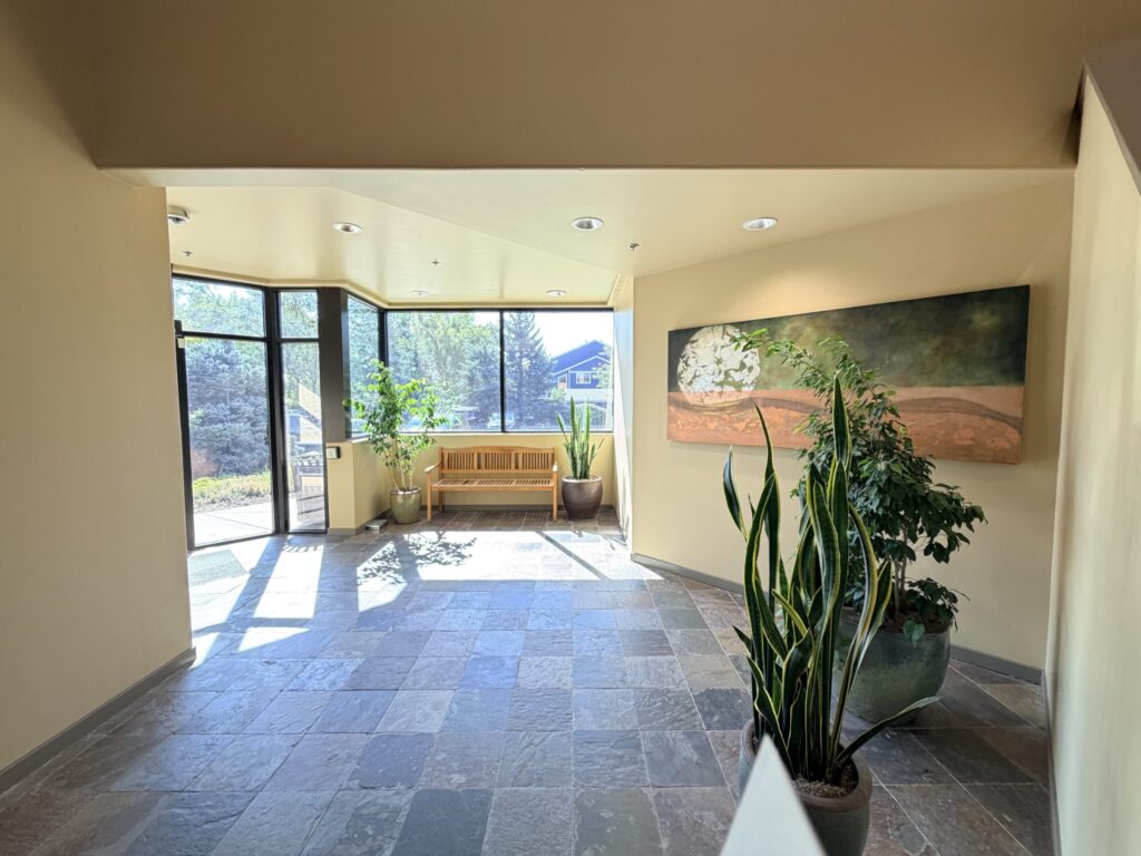 Bright lobby with slate tile floor and tall windows